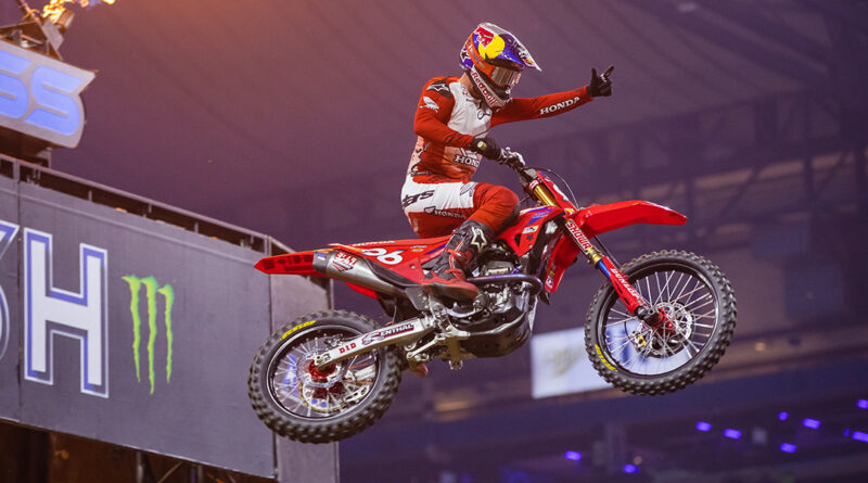 Hunter Lawrence flying through the air while lighting the torches at the Detroit AMA Supercross event